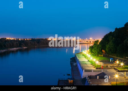 The Scenic Summer Evening View Of Sozh River, Illuminated Embankment And Ancient Greenwood Park In Gomel, Homiel, Belarus. Blue Sky Background. Stock Photo
