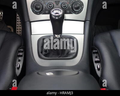 Inside car dashboard view.Detailed close-up photo of manual transmission knob/lever in neutral position.Leather upholstery,6 gear transmission/reverse Stock Photo