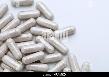 Pile of capsules with probiotic powder inside on white background. Top view, high resolution product.  Health care concept Stock Photo