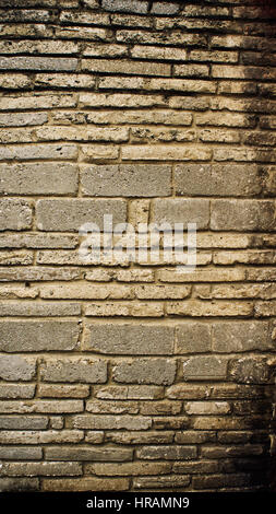Concrete wall / stone wall closeup background photo texture. Color filter effects, and some fine film noise added Stock Photo
