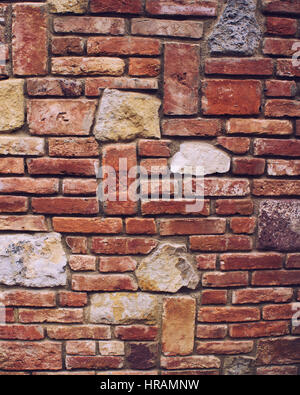 Brick wall / stone wall closeup background photo texture. Color filter effects, and some fine film noise added Stock Photo