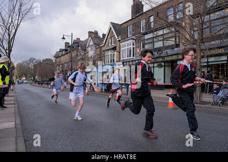 The Grove, Ilkley, West Yorkshire, UK. 28th Feb, 2017. Young competitors (school boys) take part, running in the traditional, annual Ilkley Rotary Pancake Race. Credit: Ian Lamond/Alamy Live News Stock Photo