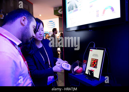 Barcelona, Spain. 28th Feb, 2017. An employee works at her booth during the second day of the Mobile World Congress in Barcelona, Spain, on Feb. 28, 2017. Credit: Lino De Vallier/Xinhua/Alamy Live News Stock Photo