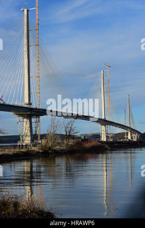 Queensferry, Scotland, UK. 28th Feb, 2017. The towers of the new Queensferry Crossing road bridge over the Forth Estuary are reflected in the waters of Port Edgar Marina, with the bridge itself appearing almost complete. The projected date of completion is May 2017, Credit: Ken Jack/Alamy Live News Stock Photo