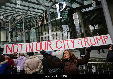 Vancouver, Canada. 28th Feb, 2017. A woman attends a protest outside the Trump International Hotel and Tower in Canada's Vancouver on Feb. 28, 2017, the building's official opening day. Credit: Liang Sen/Xinhua/Alamy Live News Stock Photo