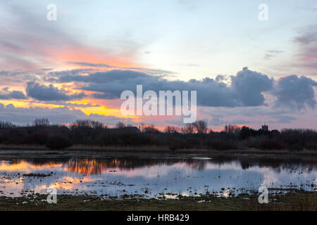 Southport, Merseyside, UK. 1st March, 2017. UK Weather. After a cold and wet day yesterday, a beautiful sunrise casts its warming rays over the wetlands of Southport's RSPB nature reserve. These naturally flooded areas provide perfect habitat for the thousands of migratory birds resting here over the winter months. Credit: Cernan Elias/Alamy Live News Stock Photo