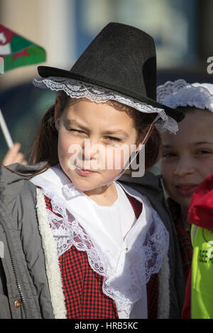 St David's Day celebrations as school children march through the town of Colwyn Bay, North Wales with welsh flags and daffodils Stock Photo