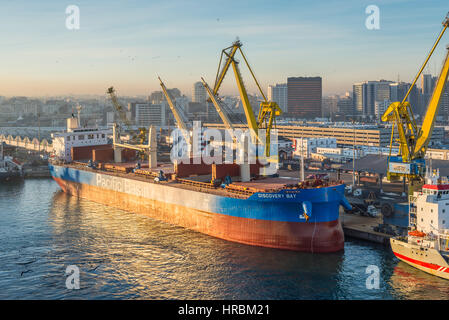 Casablanca, Morocco - December 8, 2016: Cargo vessel Discovery Bay (Bulk Carrier) early in the morning at dawn in the seaport of Casablanca, Morocco.  Stock Photo