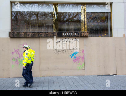 German Carnival parade in DŸsseldorf, Police officers secure the parade, Gucci shop on shopping street Kšnigsallee, windows secured by wooden panels, Stock Photo