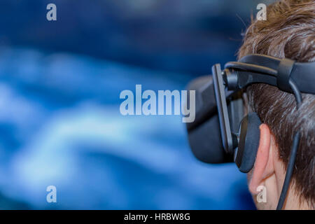 Young man wearing virtual reality glasses Stock Photo