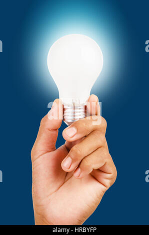 energy saving lamp in hand on blue background Stock Photo