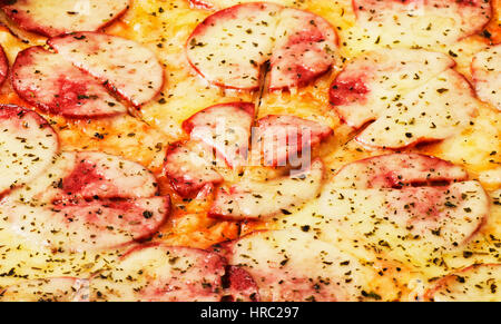 Pizza background close-up macro shot of pepperoni pizza Stock Photo