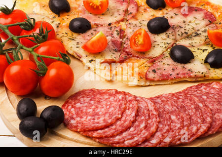 Pizza and ingredients close-up on a kitchen blackboard Stock Photo