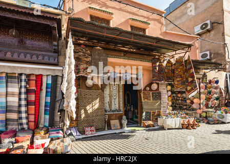 Marrakesh, Morocco - December 8, 2016: Islamic-style textiles and souvenirs on the famous souks in medina of Marrakesh, Morocco. Stock Photo