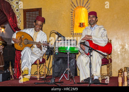 Marrakesh, Morocco - December 8, 2016: A group of two musicians playing traditional folk music in a restaurant Dar Es-Salam in Marrakesh, Morocco. Stock Photo