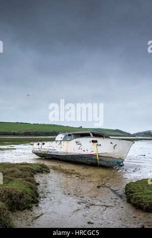 remains boat abandoned beached Gannel Estuary gloomy overcast day Newquay Cornwall UK weather Stock Photo