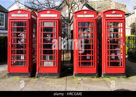 A row of four traditional iconic red telephone boxes Truro City Centre Cornwall UK. Stock Photo
