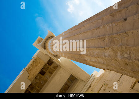 Detail of an ancient Doric column, Acropolis, Athens looking straight up from below towards the capital under a sunny blue sky Stock Photo