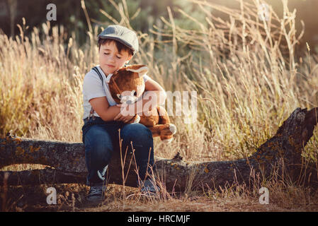 Boy hugging his teddy bear Stock Photo