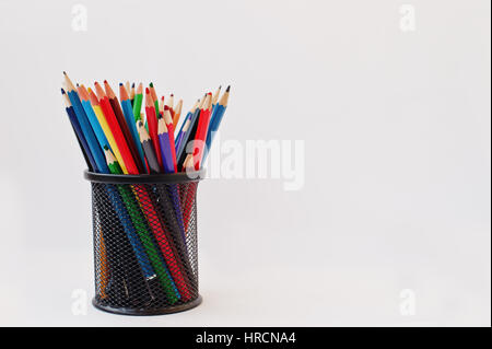 Colored pencils in black pencil case  isolated on white background. Stock Photo