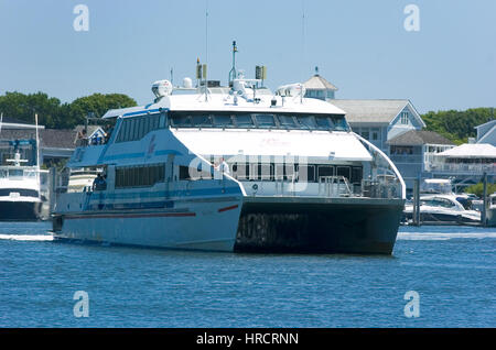 A high speed ferry boat returning to Hyannis harbor on Cape Cod from the island of Martha's Vineyard Stock Photo