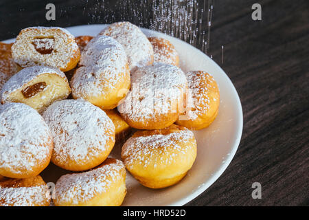 heap of marmalade filled bismarck donuts on white plate Stock Photo
