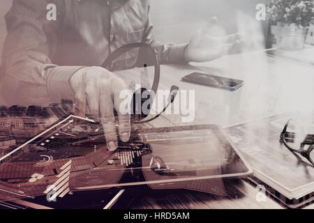 Double exposure of Businessman hand using VOIP headset with digital tablet computer,document,concept communication, it support,London architecture bul Stock Photo