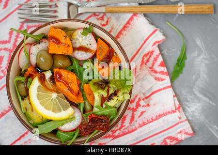 Steamed sweet potato, broccoli and other vegetables salad in the bowl. Love for a healthy vegan food concept Stock Photo