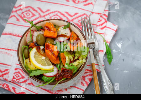 Steamed sweet potato, broccoli and other vegetables salad in the bowl. Love for a healthy vegan food concept Stock Photo