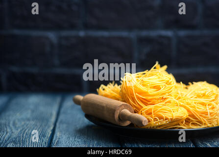 raw noodles from chicken yolks on a table Stock Photo