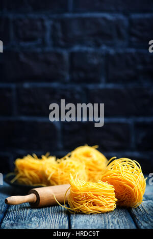 raw noodles from chicken yolks on a table Stock Photo