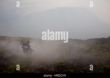 Climbing Mount Nyiragongo in Virunga National Park, Democratic Republic of Congo is an exciting adventure. The active volcano's crater holds lava lake. Stock Photo