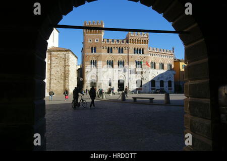 Grosseto Palazzo Aldobrandeschi facade view through an arch against a clear blue sky - Piazza Dante Alighieri, Grosseto, Tuscany, Italy, Europe Stock Photo