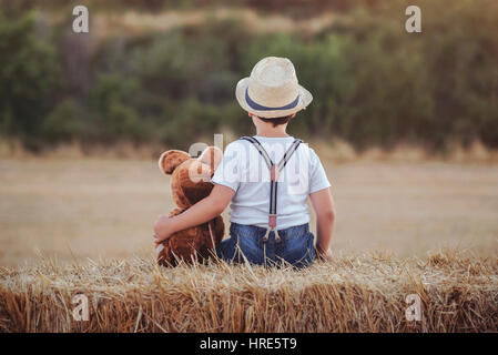 Boy hugging teddy bear in bed Stock Photo - Alamy
