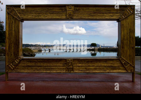 View through a huge picture frame at Maffeo Sutton Park, Nanaimo, Vancouver Island, BC, Canada to the Swy-a-Lana Lagoon Stock Photo
