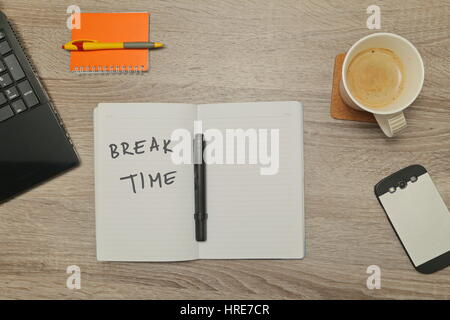 Open notebook with MESSAGE and a cup of coffee on wooden background. Top down view Stock Photo