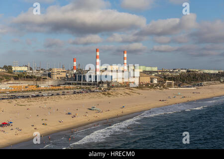 Los Angeles, California, USA - August 6, 2016:  Aerial view of Dockweiler State Beach, power generating station and oil refinery tanks. Stock Photo