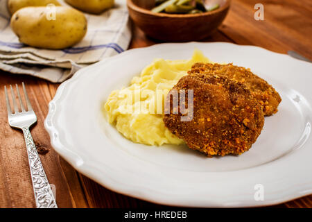 Fried minced meat with cheese and mashed potatoes on white plate Stock Photo