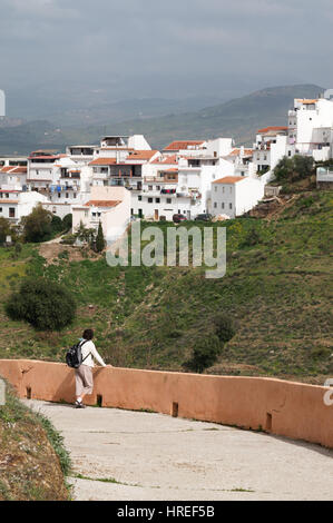 A woman looks towards the village of Alora in Spain, Europe Stock Photo