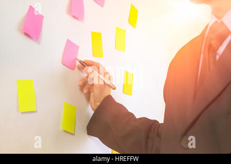 Business Man. Business man putting idea on board. Business man using pen for create business planning. Business accessory background. Business working Stock Photo