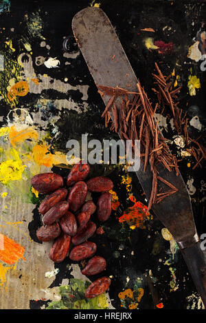 shredded chocolate and cocoa beans  on vintage painted background Stock Photo