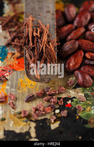 shredded chocolate and cocoa beans  on vintage painted background Stock Photo