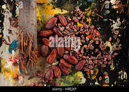 raw cacao nibs, shredded chocolate and cocoa beans  on vintage painted background Stock Photo