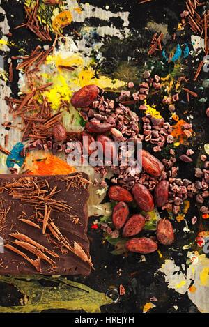 raw cacao nibs, shredded chocolate and cocoa beans  on vintage painted background Stock Photo