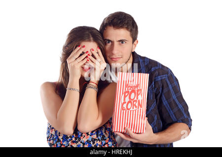 Portrait of a young beautiful couple eating popcorn and watching movies. Isolated white background. Stock Photo