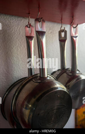 Hanging pots on a metal rack contain Petunias Petunia and Geraniums ...