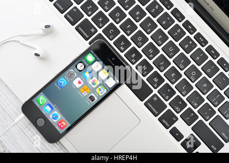 KIEV, UKRAINE - JANUARY 29, 2015: Apple iPhone 5s and MacBook Air on table. Apple Inc. is an American multinational corporation that designs, develops Stock Photo