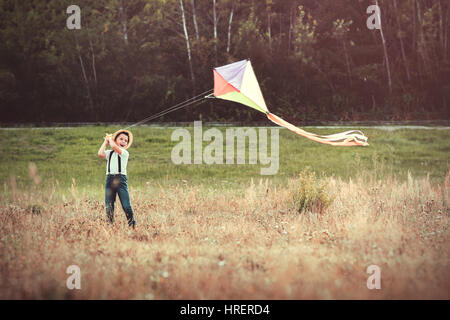 Boy with kite. Child flying kite on nature Stock Photo