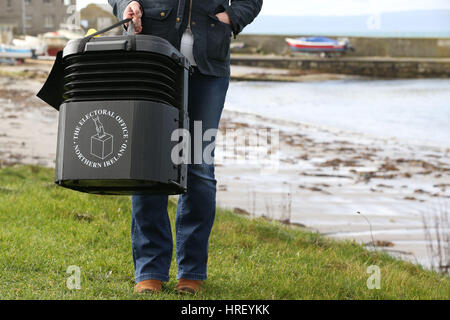 Senior presiding officer and polling station manager Teresa McCurdy on Rathlin Island, off the north east coast of Northern Ireland, with the ballot box in which the island's population of just over 100 people will cast their votes during Thursday Assembly election. Stock Photo