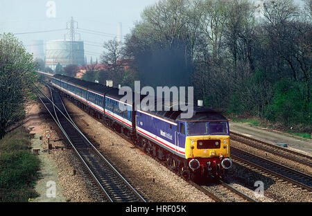 A Network SouthEast class 47 working a ”Network Express' service on the approach to Fulscot Bridge, Didcot. 11th April 1992.  47581 opens up after cro Stock Photo